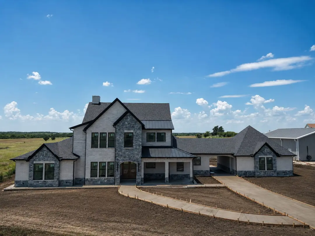 Celeste Residence straight-on front elevation with stone and brick in Celeste, Texas Celeste Residence straight-on front elevation with stone and brick in Celeste, Texas