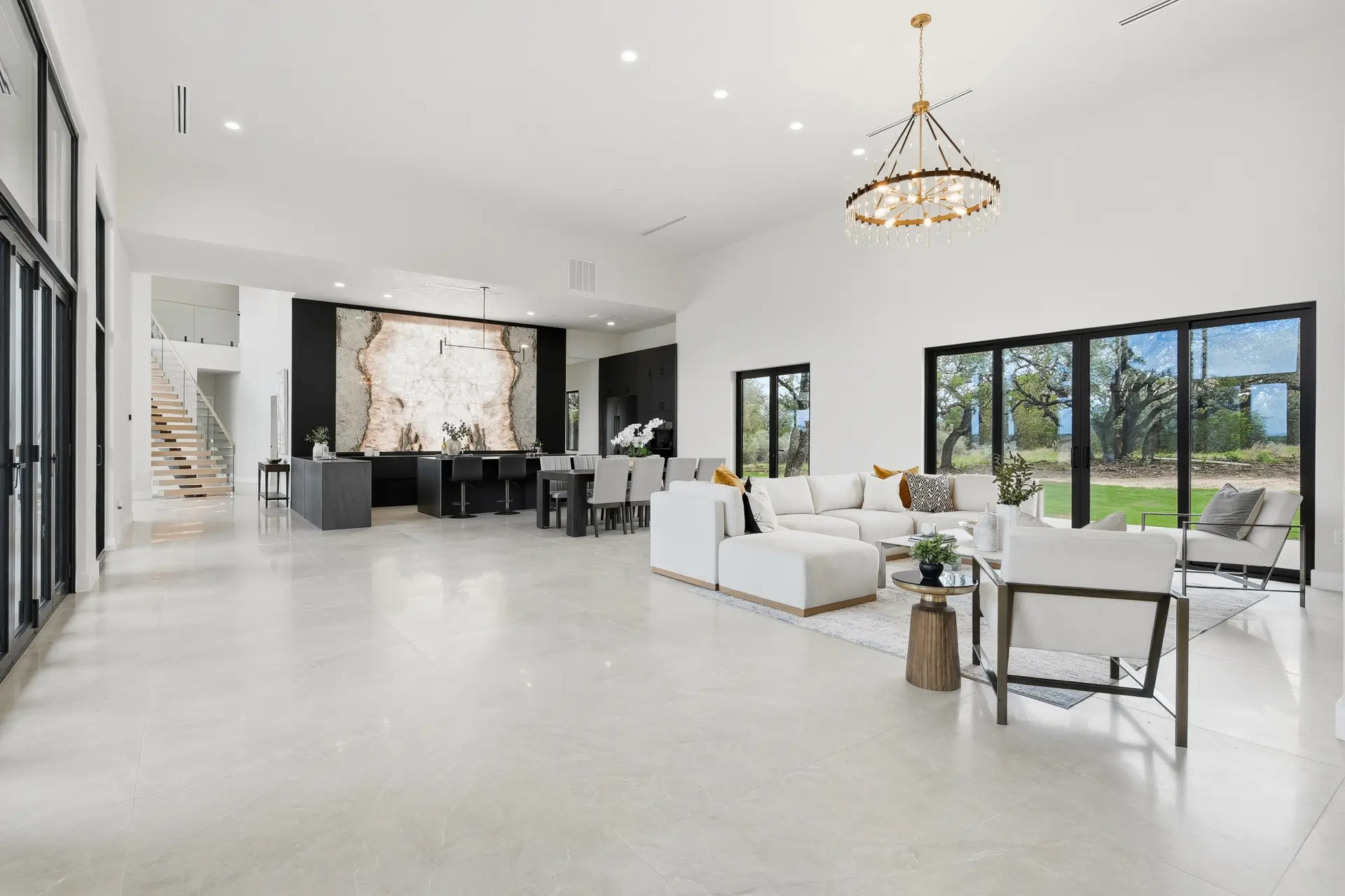 Bluewater Residence open-plan great room with high ceiling and glass doors in Lago Vista, Texas