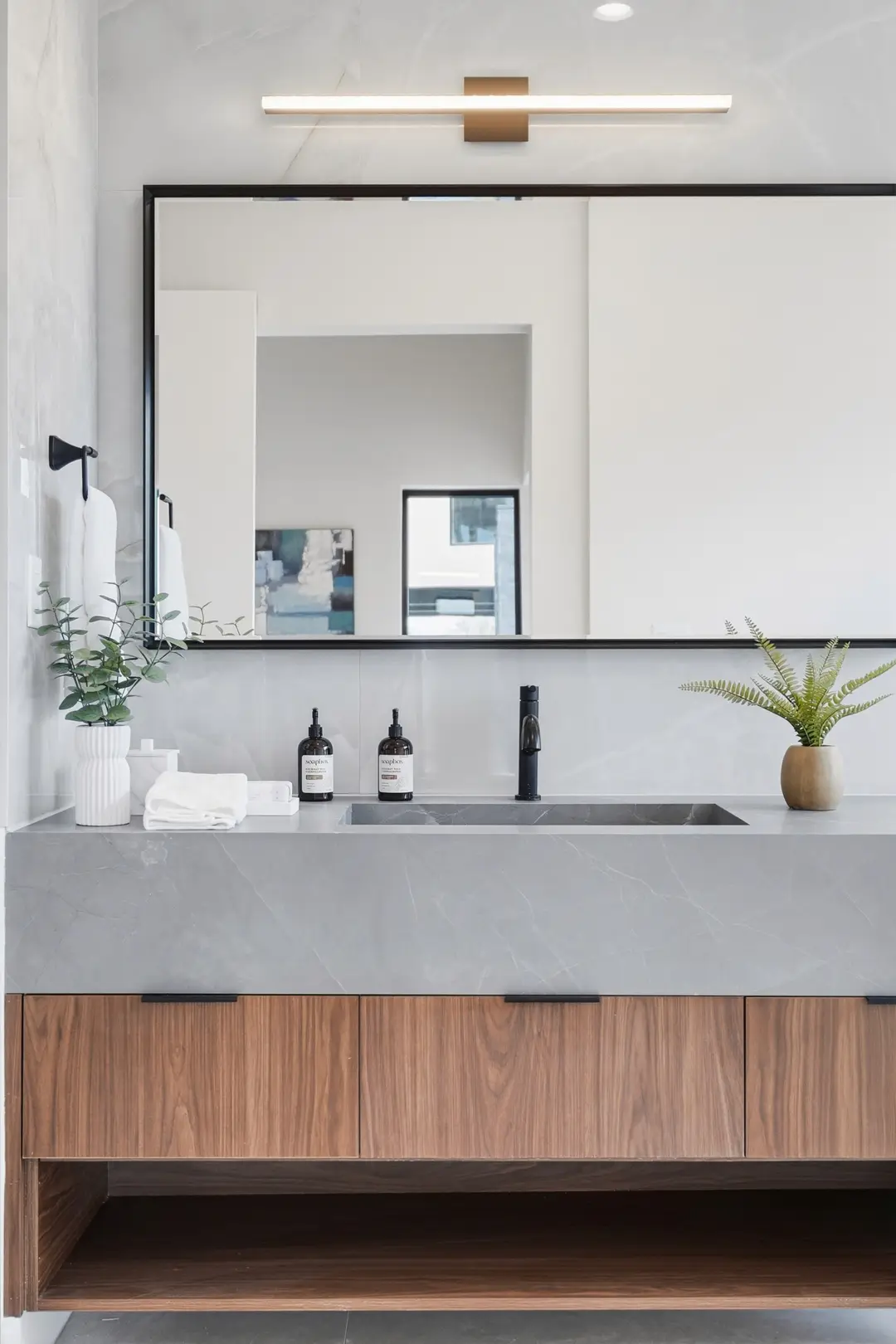Bluewater Residence bathroom floating walnut vanity with stone top and mirror in Lago Vista, Texas