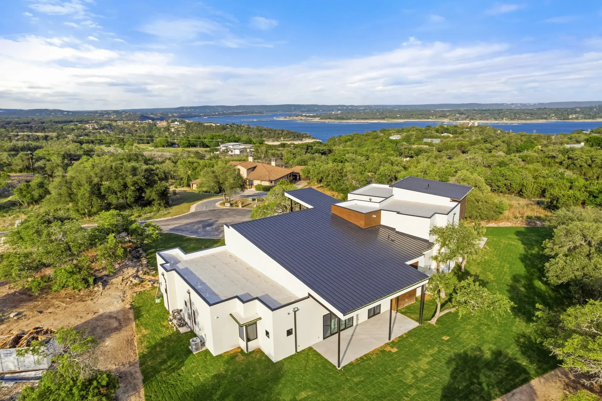 Bluewater Residence aerial view of standing-seam roof with water in the distance in Lago Vista, Texas