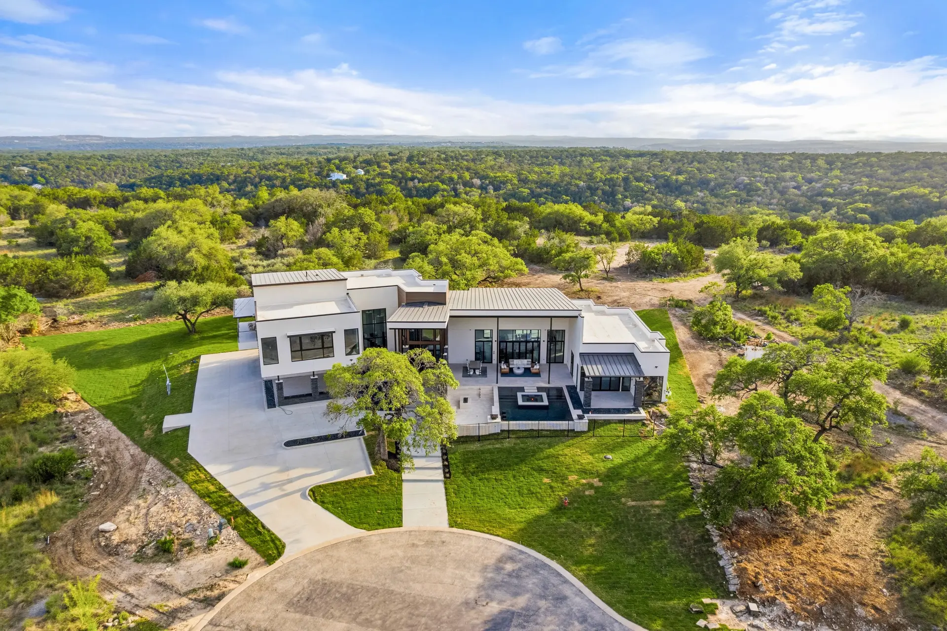 Bluewater Residence aerial view of home on wooded hilltop lot in Lago Vista, Texas